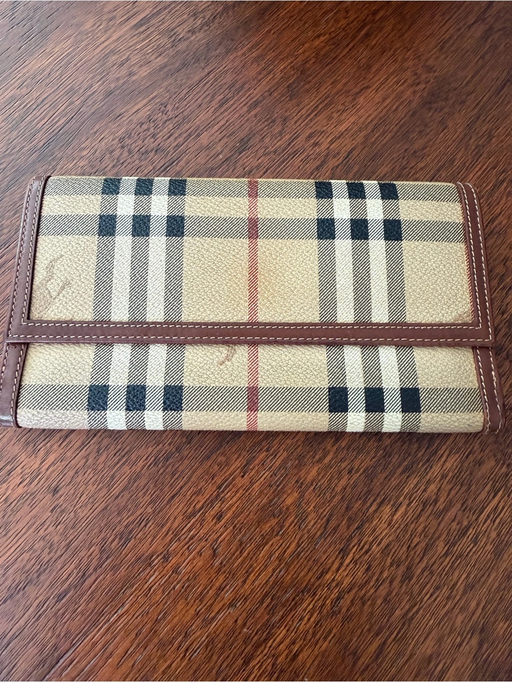 Burberry Classic long folded wallet. Will include a gold chain.